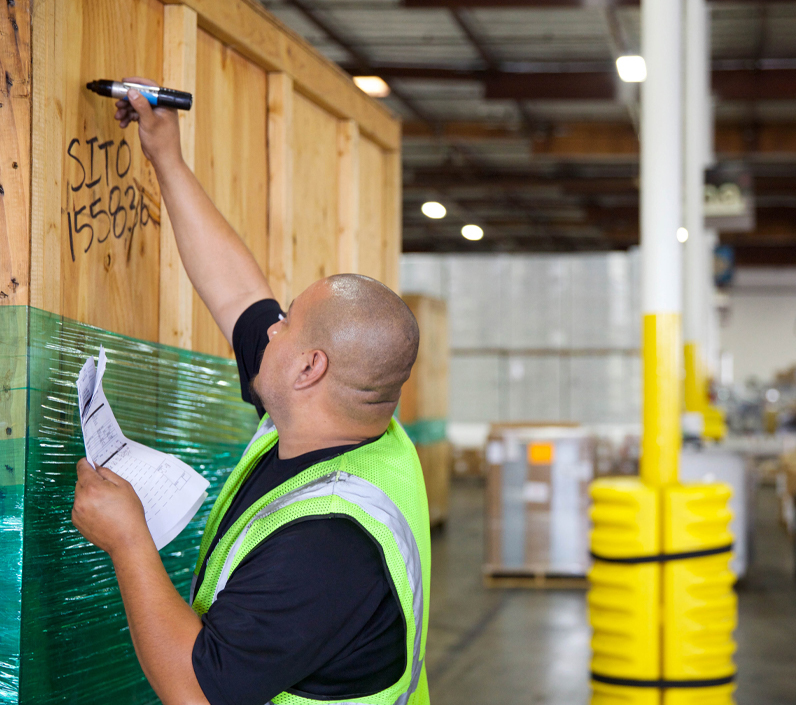 warehouse-writing-crate-2-cs-right warehouse worker writing on crate