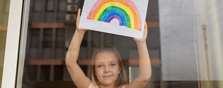 young girl with rainbow drawing