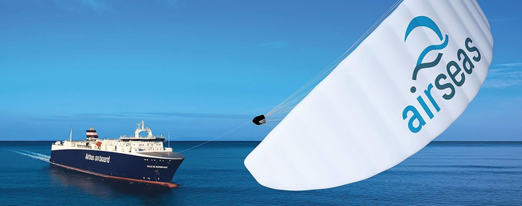 Cargo ship with sky sail attached flying in the wind
