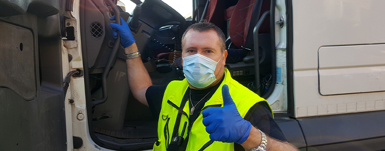 young transporter on the truck with face mask and protective gloves