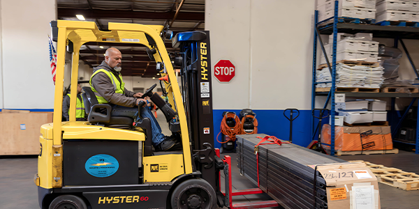 Man loading freight with a pallet lift